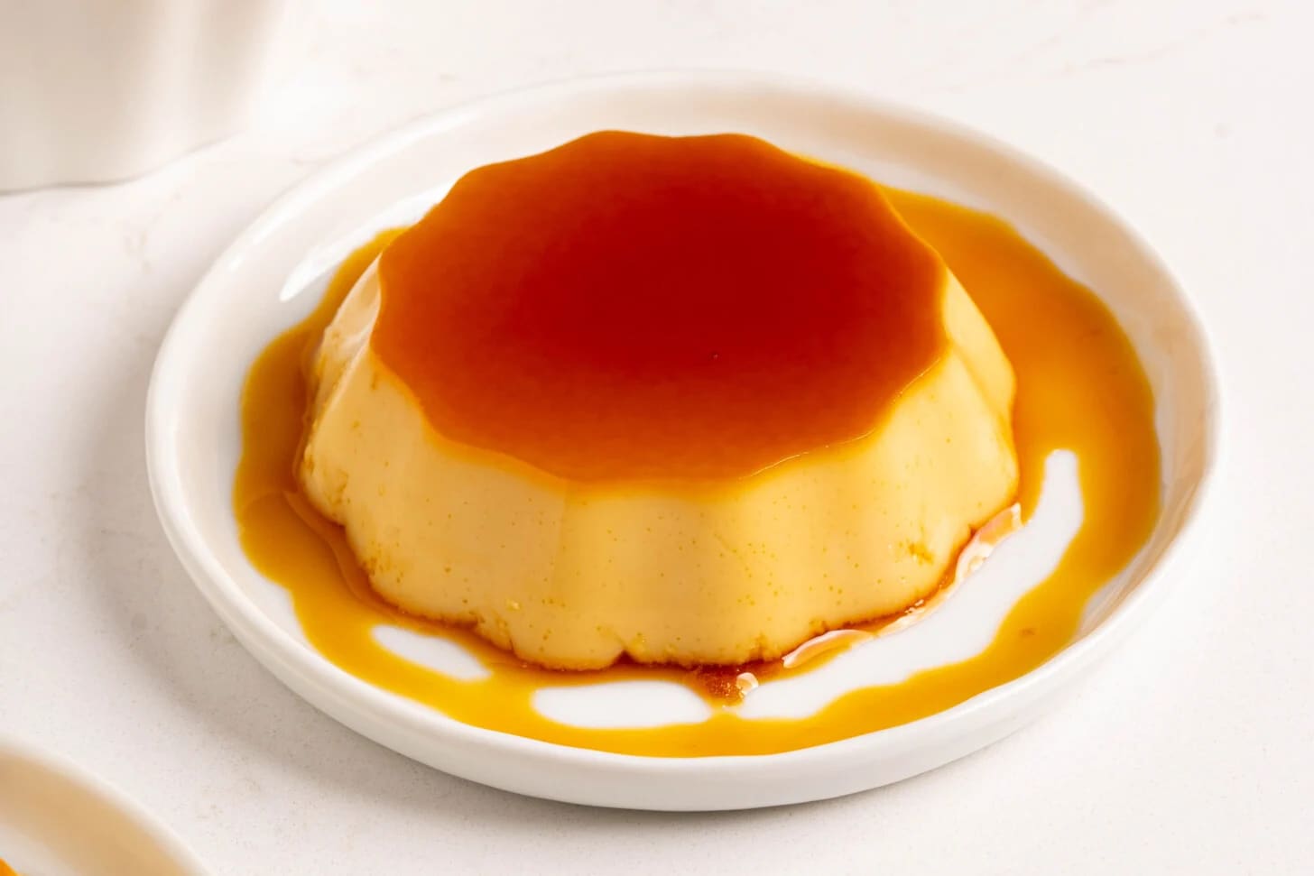 Perfect banh flan with golden caramel sauce flowing down the sides of the silky custard